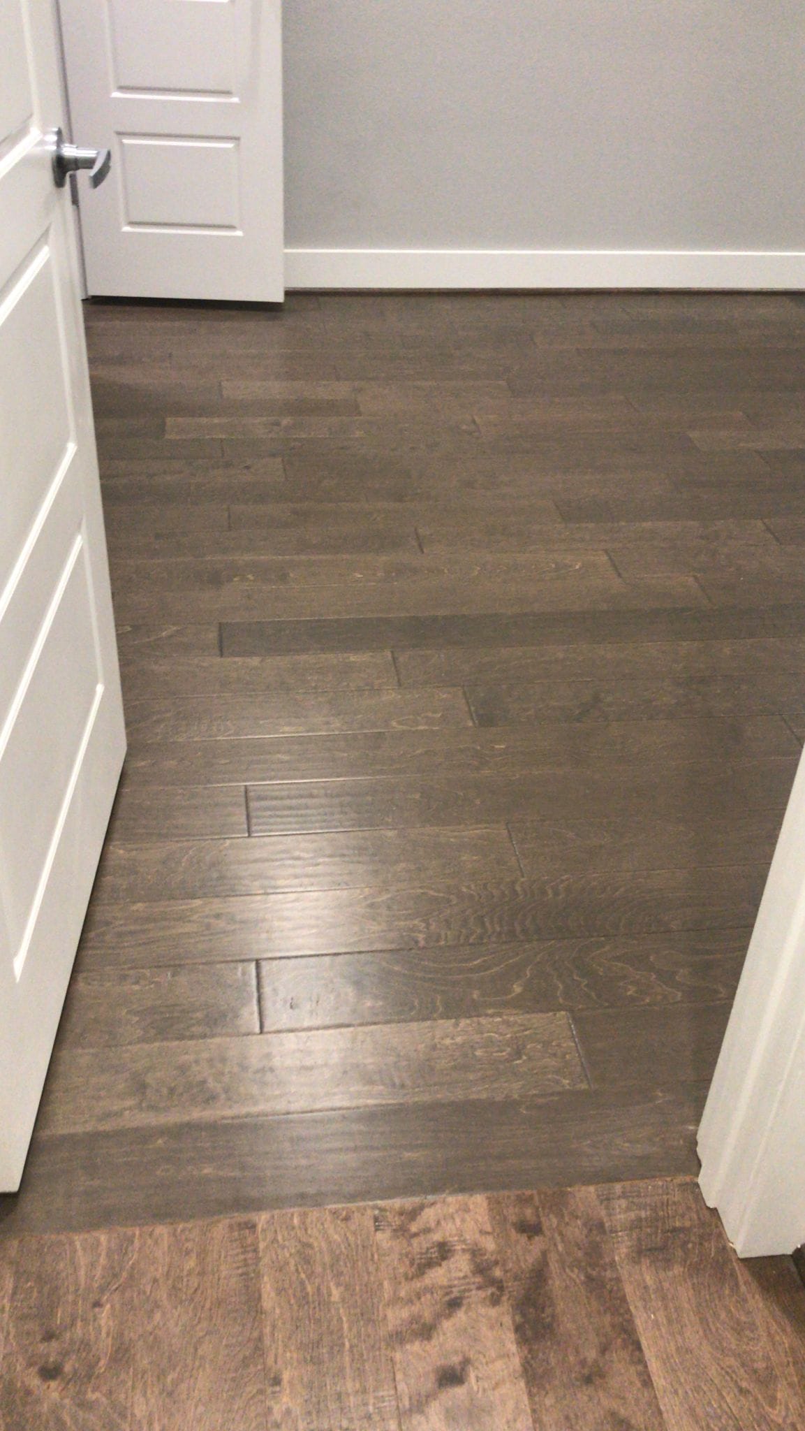 Wide-plank luxury vinyl in a soft gray oak tone