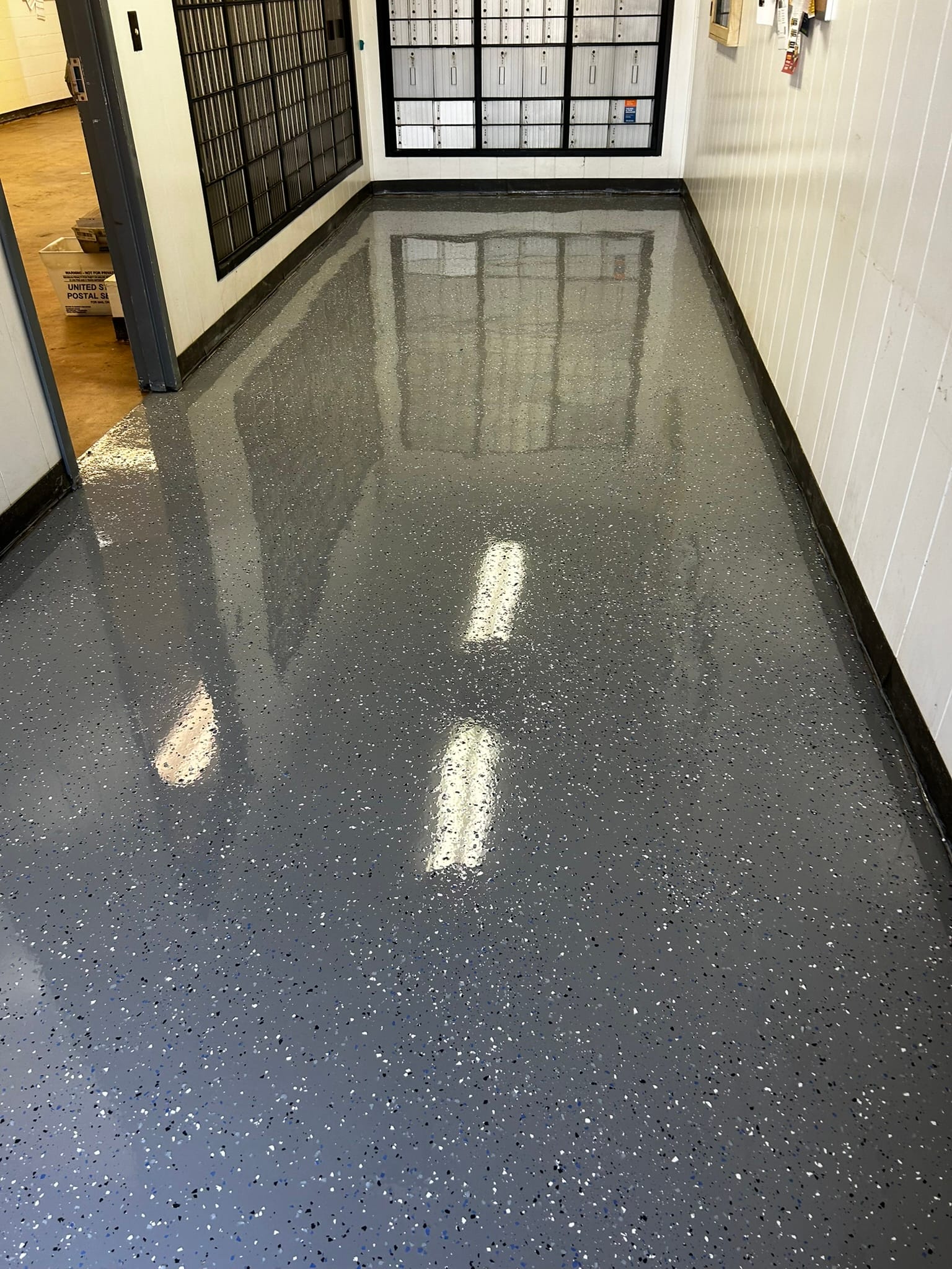 Decorative epoxy flake floor in a facility corridor